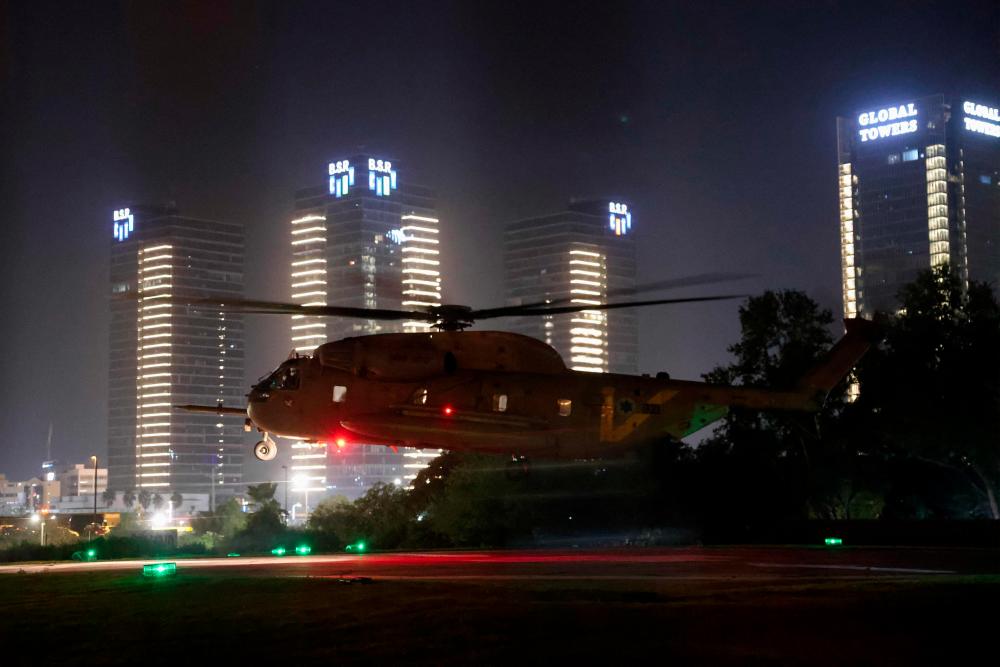 An Israeli helicopter with released hostages prepares to land at Tel Aviv's Schneider medical centre on November 24, 2023. - AFPPIX