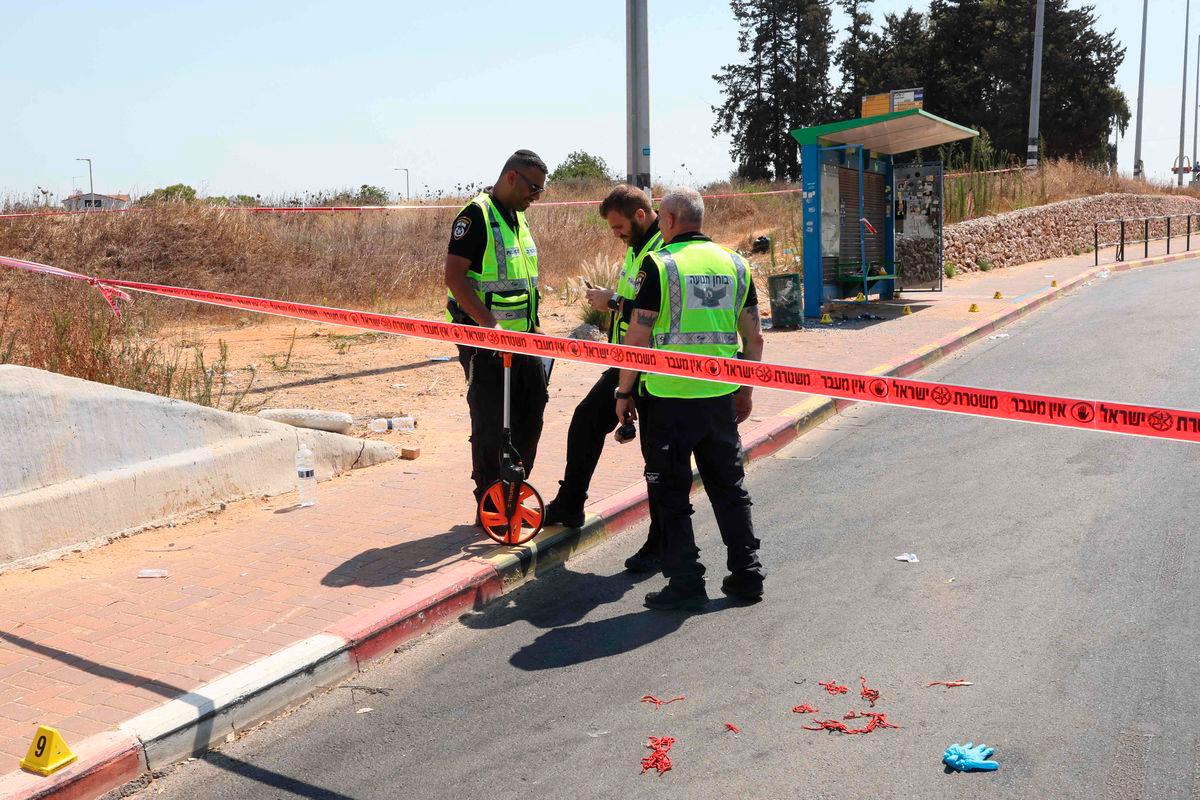 Israeli police conduct a search at the site of a reported ramming attack in the central Israeli city of Kfar Yona on July 24, 2025. (Photo by Jack GUEZ / AFP)