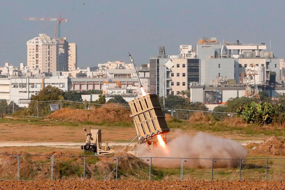 An Israeli missile is launched from the Iron Dome defence missile system, designed to intercept and destroy incoming short-range rockets and artillery shells, in the southern Israeli city of Ashdod on Nov 12, to intercept rocket launched from the nearby Palestinian Gaza Strip. — AFP