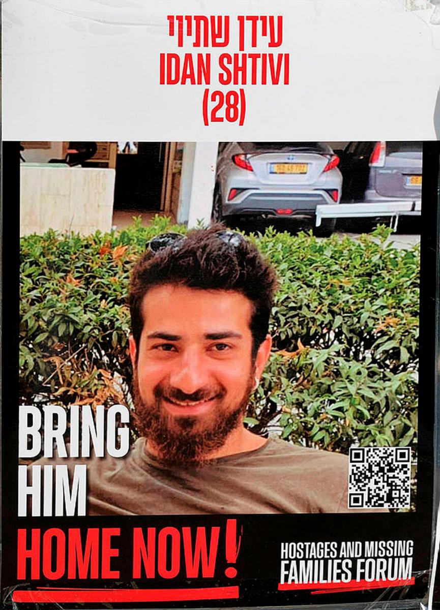 This photo shows a poster bearing a portrait of Idan Shtivi, one of the Israelis held hostage in the Gaza Strip since October 2023, set up in a square in Tel Aviv on January 21, 2025. The remains of the second of two hostages recovered from Gaza this week have been identified as belonging to Idan Shtivi, the Israeli prime minister’s office said on August 30, 2025. (Photo by AFP)