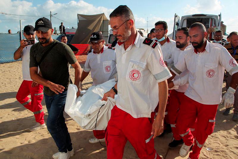 Members of Palestine Red Crescent Society (PRCS) carry the bodies of their two fellow paramedics, who according to medics, were killed when an ambulance on a mission to rescue people was hit in an Israeli strike, during their funeral in Rafah in the southern Gaza Strip, May 30, 2024. - REUTERSPIX