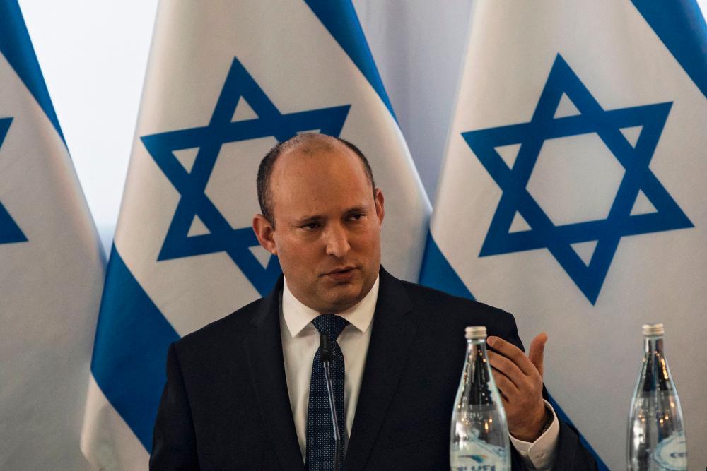 Israeli Prime Minister Naftali Bennett (C) heads the weekly cabinet meeting in Kibbutz Mevo Hama in the Israeli-annexed Golan Heights, on December 26, 2021. AFPPIX
