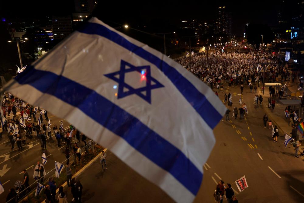 People waving Israel’s national flag take part in a protest in Tel Aviv, against the government’s controversial judicial overhaul bill, on March 25, 2023. AFPPIX