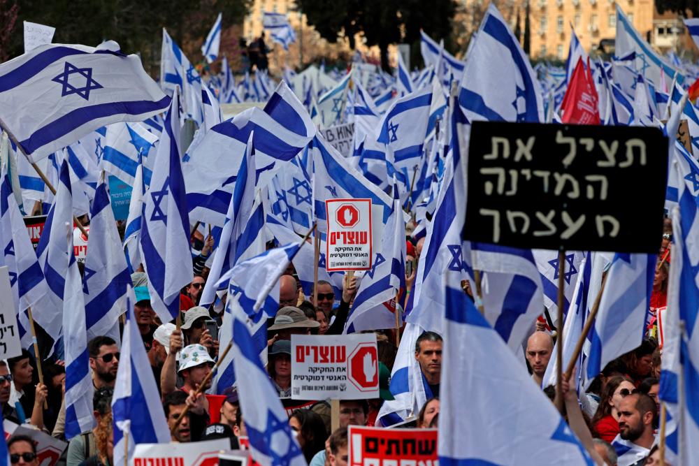 Protesters gather with placards and national flags outside Israel’s parliament in Jerusalem amid ongoing demonstrations and calls for a general strike against the hard-right government’s controversial push to overhaul the justice system, on March 27, 2023. AFPPIX