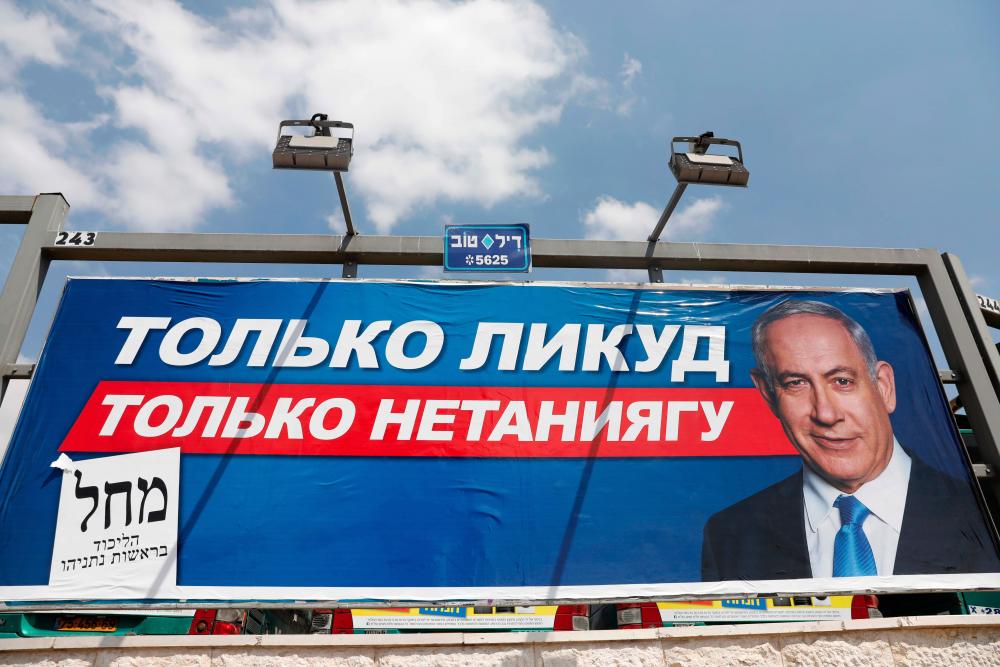 An Israeli election billboard showing Likud chairman and Prime Minister Benjamin Netanyahu with a caption in Russian reading ‘Only Likud, only Netanyahu’, is displayed in Jerusalem on Sept 14, 2019. - AFP