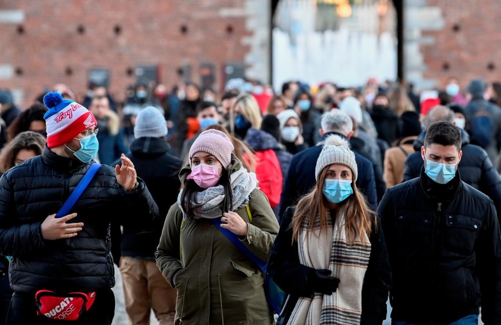 People wear face masks amid the coronavirus disease (Covid-19) pandemic in Milan, Italy, November 28, 2021. REUTERSpix