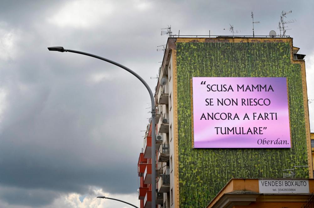 A view taken on April 14, 2021 in Rome shows an advertising board reading sorry mom if I still can't get you buried after a man put up several billboards across Rome to honour his dead mother and draw attention to a burial crisis as the coronavirus pandemic continues to grip Italy. –AFP