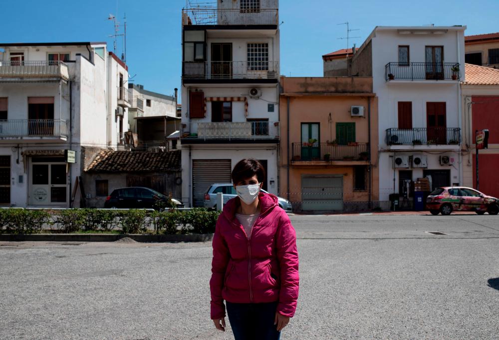 Bruna Filippone, a Locri resident who in February started a citizen's group 'Defend the Hospital', poses in the southern city of Locri in the Italian Calabria region, on April 7, 2020. At the Locri hospital in southern Italy, patients are often sent elsewhere for lack of doctors, the elevators are endlessly in disrepair and the CT scan works one day, but not the next. Infiltration by the mafia, major doctor shortages, and a regional health agency hundreds of millions of euros in debt are just a few of the challenges the hospital confronted in 2019 alone. And that was before coronavirus. — AFP