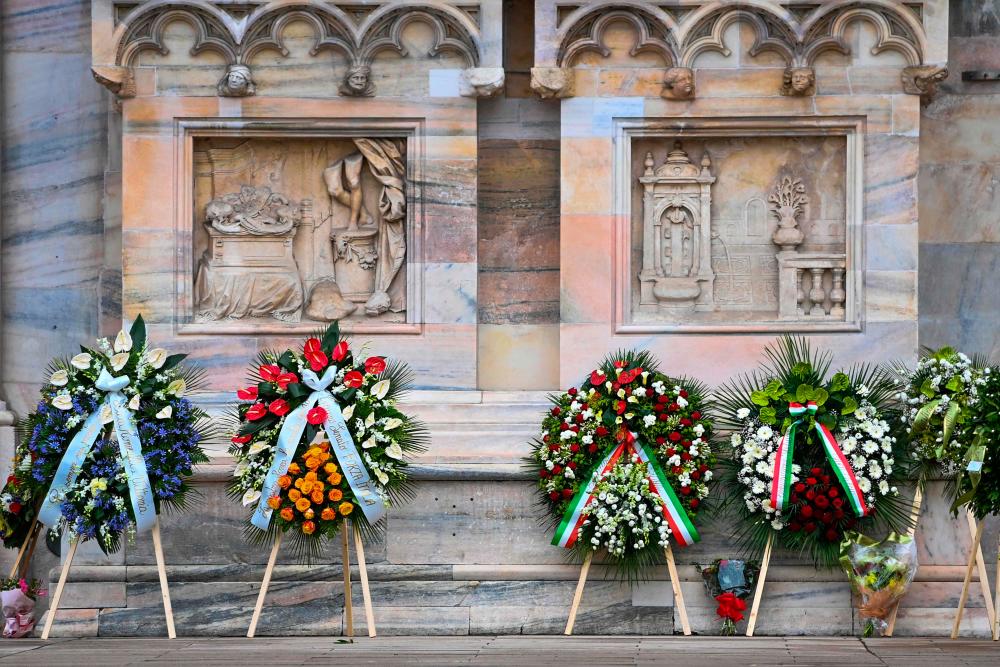 Wreaths of flowers are laid in front of the Duomo cathedral in Milan on June 14, 2023 ahead of the state funeral for Italy’s former prime minister and media mogul Silvio Berlusconi. AFPPIX