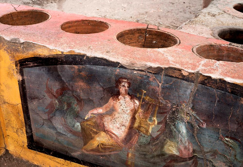 $!This picture released on December 26, 2020 by the Pompei Press Office shows a thermopolium, a sort of street “fast-food” counter in ancient Rome, that has been unearthed in Pompei, decorated with polychrome motifs and in an exceptional state of preservation. AFP PHOTO / POMPEI PRESS OFFICE