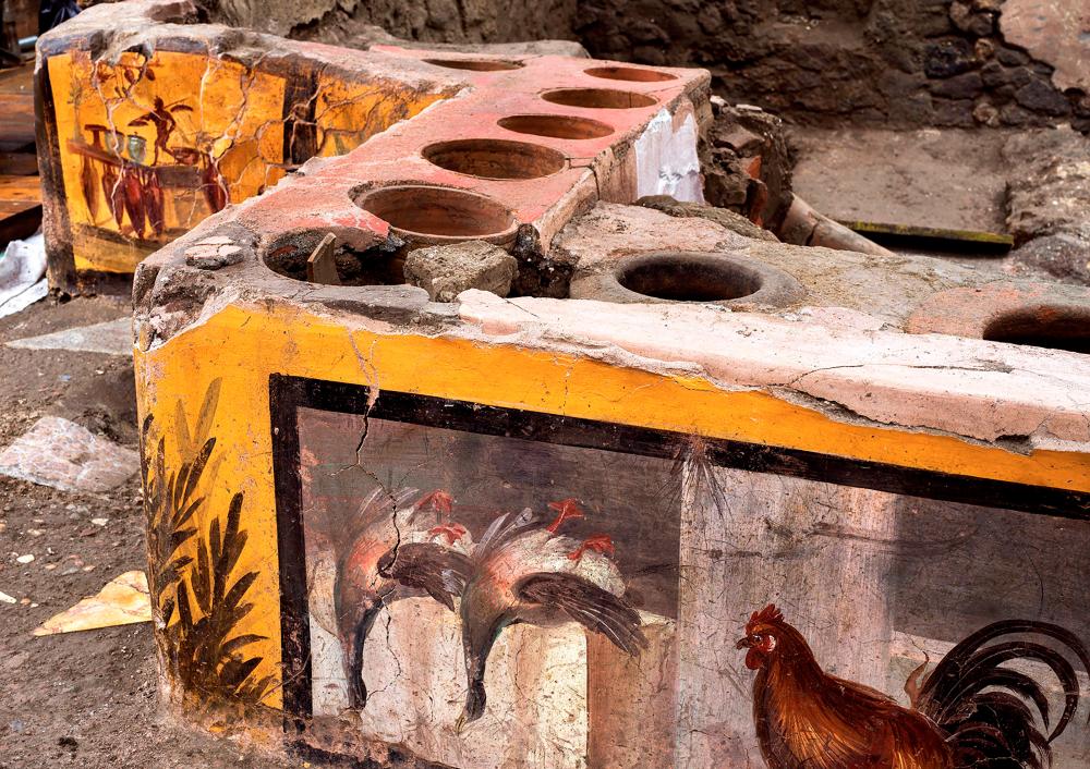$!This picture released on December 26, 2020 by the Pompei Press Office shows a thermopolium, a sort of street “fast-food” counter in ancient Rome, that has been unearthed in Pompei, decorated with polychrome motifs and in an exceptional state of preservation.AFP PHOTO / POMPEI PRESS OFFICE
