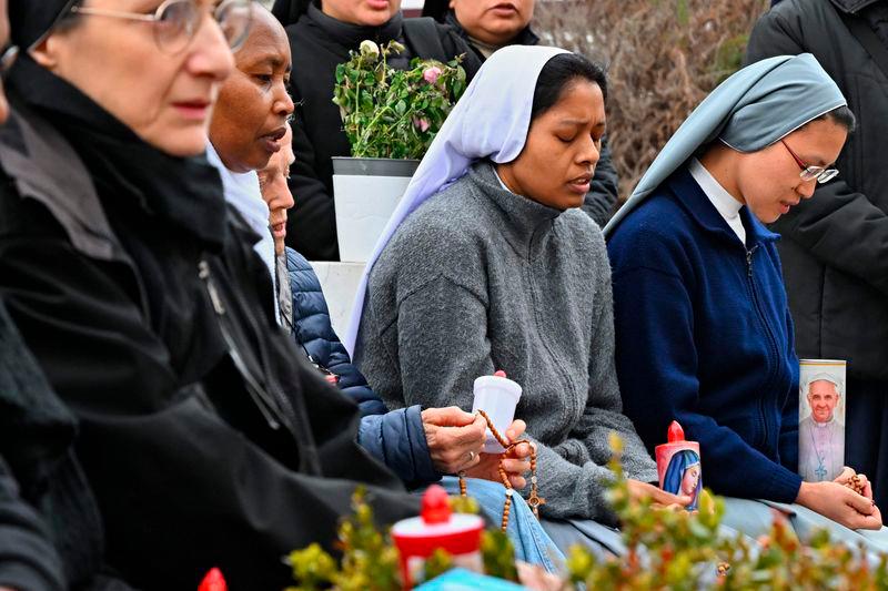 Nuns pray at the statue of John Paul II outside the Gemelli University Hospital where Pope Francis is hospitalized with pneumonia, in Rome on March 9, 2025. AFPpix