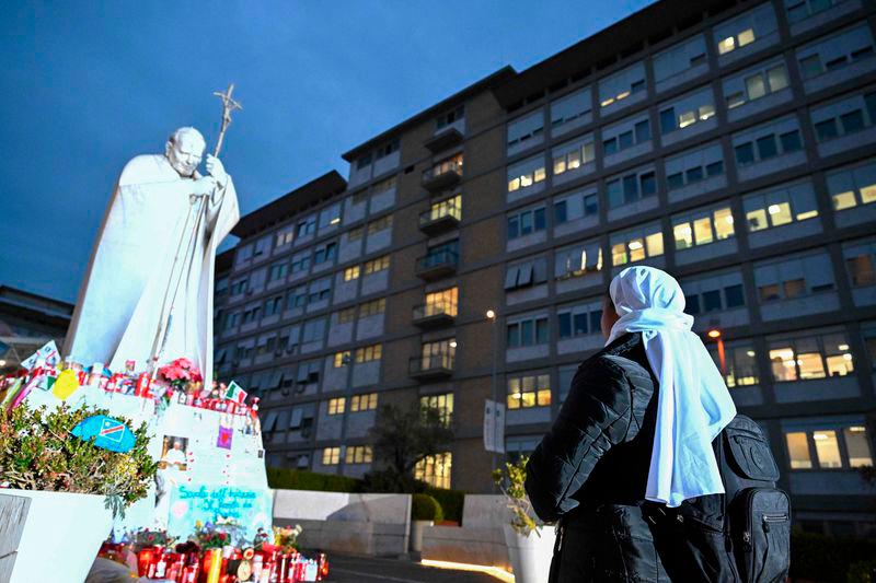 Nuns pray at the feet of a statue of John Paul II at the Gemelli Hospital where Pope Francis is hospitalised, in Rome. AFPpix