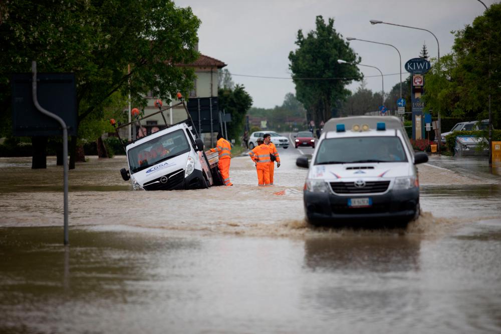 Rescuers stand by a truck following floods in Castel Bolognese, near Ravenna, on May 3, 2023. Two people died after 48 hours of almost continuous rain caused flooding in northern Italy, officials said on May 3. AFPPIX