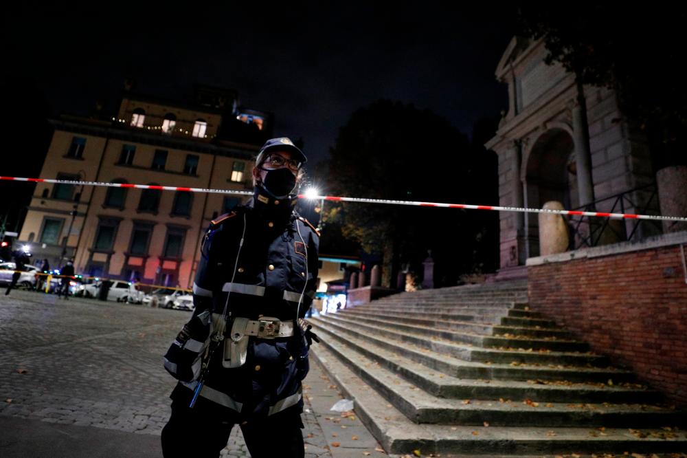 Police block access to Piazza Trilussa in Trastevere as areas of Rome prone to large gatherings of people are closed three hours before a midnight curfew to curb coronavirus disease (Covid-19) infections in Rome, Italy, October 23, 2020. — Reuters