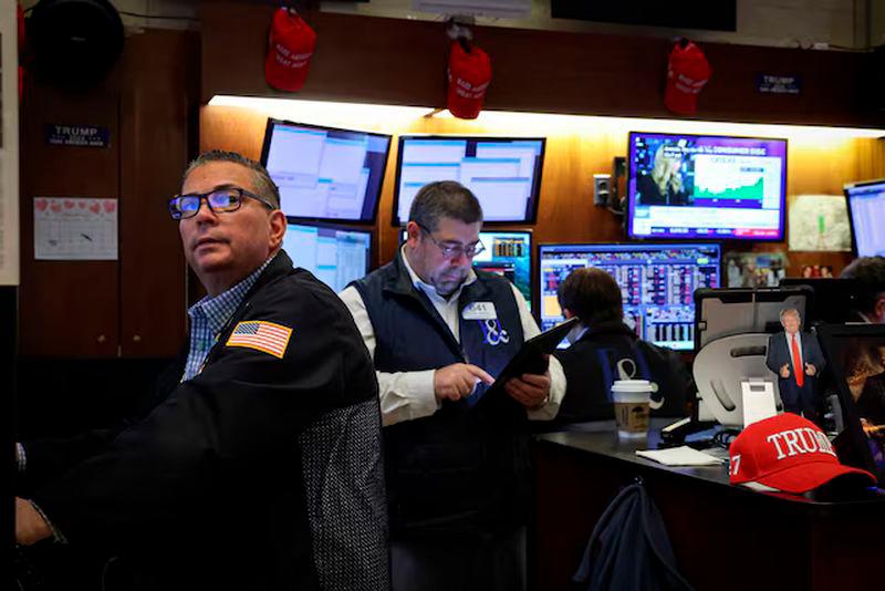 Traders work on the floor at the New York Stock Exchange (NYSE) in New York City - REUTERSpix