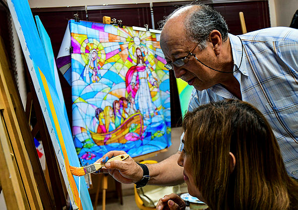 Ecuadorean artist Ivan Delgado and his students work on panels that will be part of a giant mural, that will backdrop Pope Francis’ mass during the World Youth Day, in Panama City on December 27, 2018 — AFP