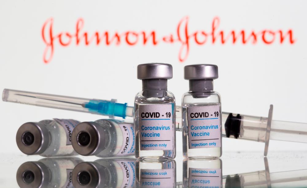 Vials labelled Covid-19 Coronavirus Vaccine and syringe are seen in front of a Johnson &amp; Johnson logo in this illustration taken, February 9, 2021. — Reuters