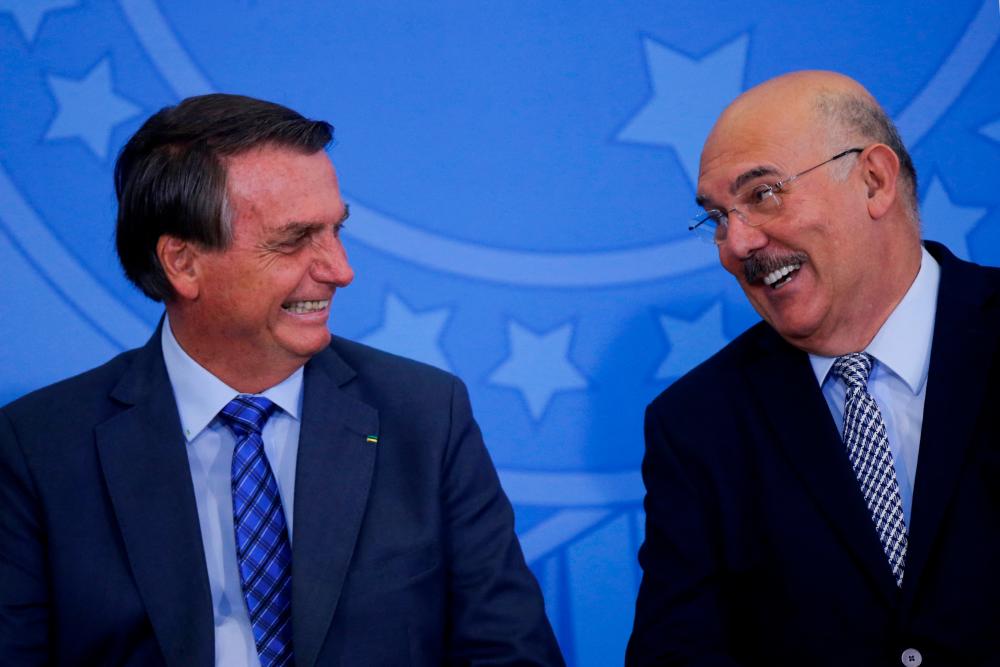 File photo: Brazil's President Jair Bolsonaro speaks with Milton Ribeiro during a signing ceremony to authorise a salary increase for teachers, at the Planalto Palace in Brasilia, Brazil February 4, 2022. REUTERSpix