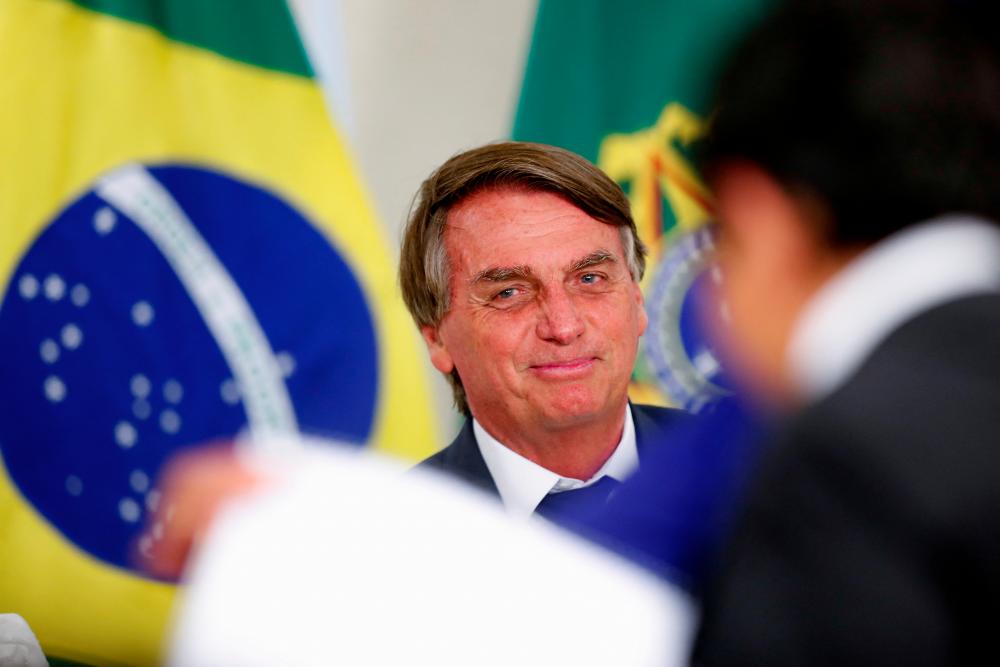 Brazil's President Jair Bolsonaro looks on during a ceremony at the Planalto Palace in Brasilia, Brazil May 18, 2022. REUTERSpix