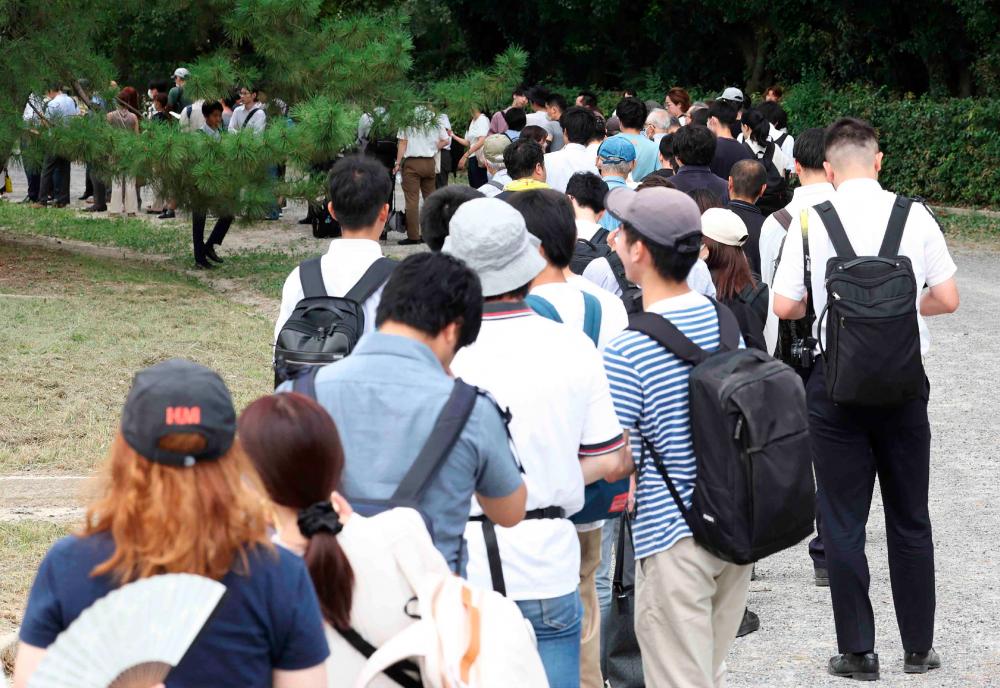 People wait in line for tickets to attend the first trial of Shinji Aoba, the defendant in the Kyoto Animation arson murder case, in Kyoto on September 5, 2023. AFPPIX