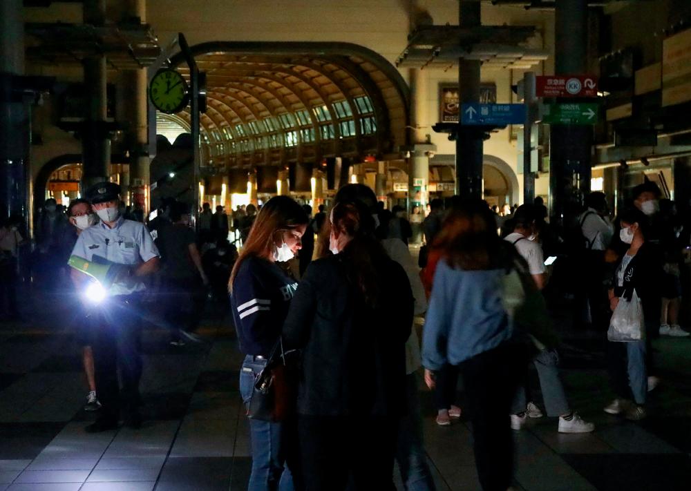 Passengers wait at the Shinagawa station as train services are suspended in Tokyo on early October 8, 2021 after a 6.1-magnitude earthquake shook the Japanese capital and surrounding areas. AFPpix