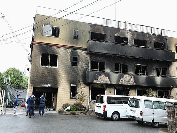Japanese police officers inspect the scene where over 30 people died in a fire at the Kyoto Animation studio building in Kyoto on July 19, 2019. — AFP