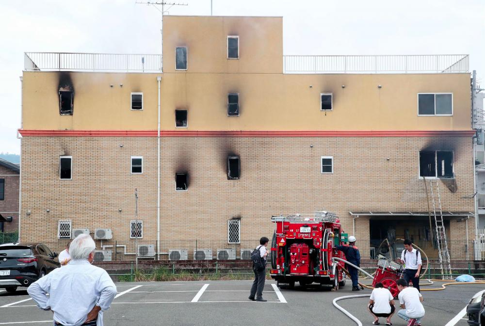 Fire fighters inspect an animation company which caught fire in Kyoto on July 18, 2019. A fire at an animation company in Japan’s Kyoto on July 18 killed one person and injured dozens more, several of them seriously, a fire department spokesman said. — AFP