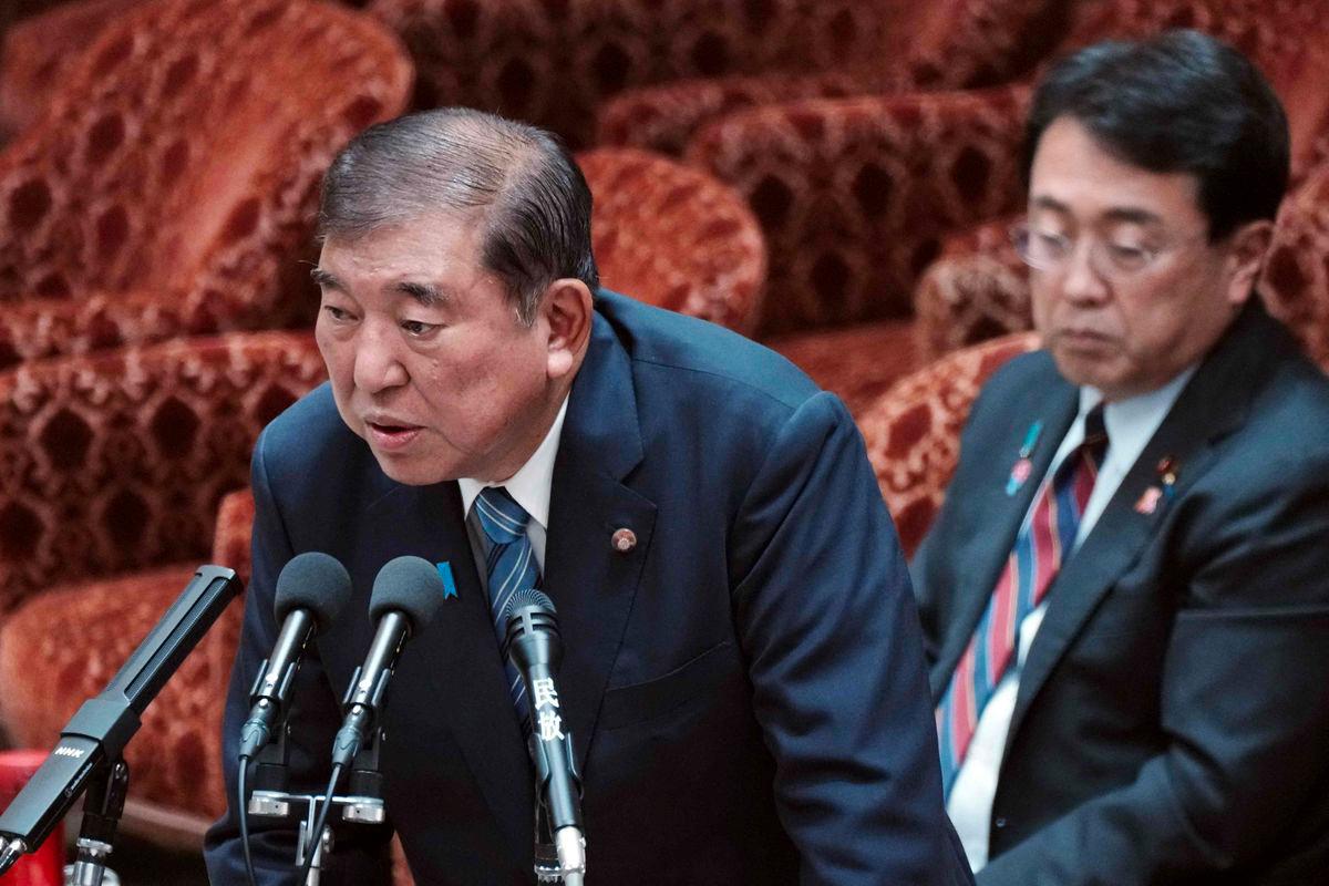 Japan's Prime Minister Shigeru Ishiba (L) and Economic Revitalization Minister and chief negotiator in trade tariff talks Ryosei Akazawa (R) attend a budget committee session on the US tariff issue in the House of Representatives at the Parliament in Tokyo on August 4, 2025. - AFPPIX