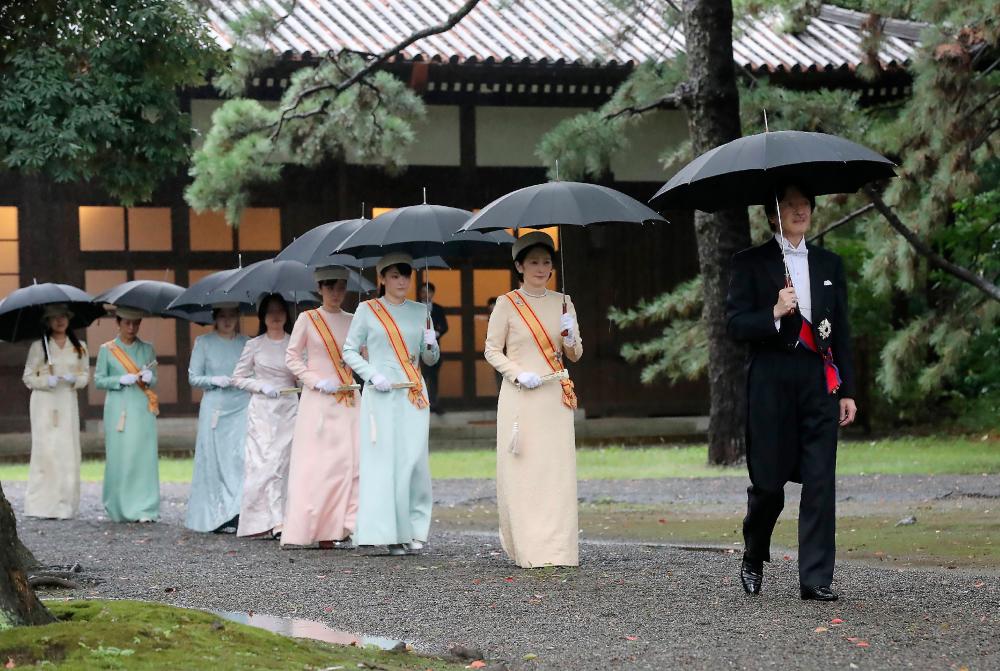 Japan's Crown Prince Akishino (R), his wife Crown Princess Kiko (2nd R) and other members of the imperial family arrive at the Imperial Palace sanctuaries where Emperor Naruhito will report the proclamation of his ascension to the throne in Tokyo on Oct 22, 2019. — AFP