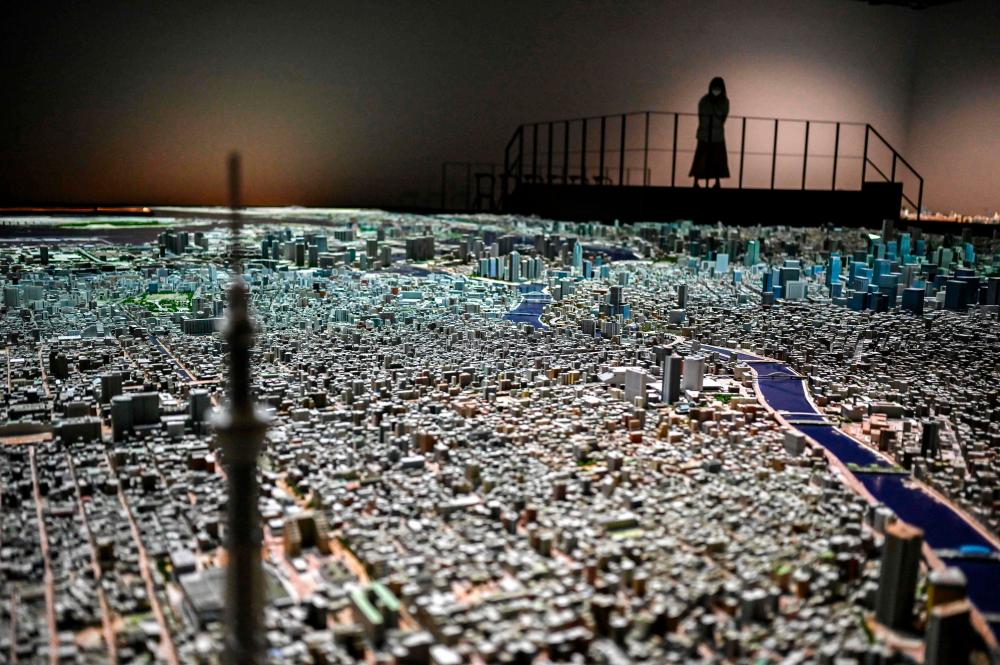 This picture taken on December 14, 2020 shows a 3-D model of the Japanese capital Tokyo in a miniaturised 1:1,000 scale version, presented by the Urban Lab project at Tokyo's Mori Building. / AFP / Charly TRIBALLEAU