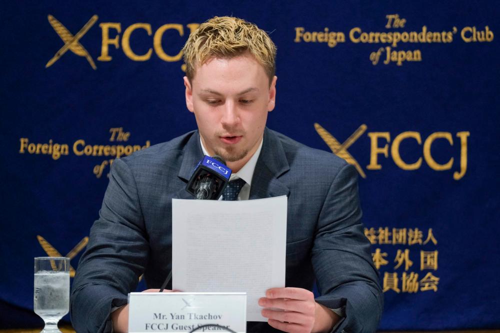 Ukrainian YouTuber Yan Tkachov reads a message during a press conference whit his older brother Sava Tkachov (not in picture) at the Foreign Correspondents’ Club of Japan in Tokyo on March 31, 2022. AFPPIX