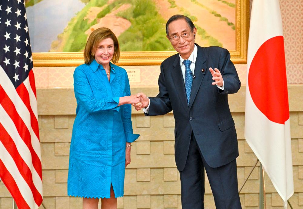 US House Speaker Nancy Pelosi (L) shakes hands with Hiroyuki Hosoda, speaker of Japan’s House of Representatives, during a meeting in Tokyo on August 5, 2022. AFPPIX