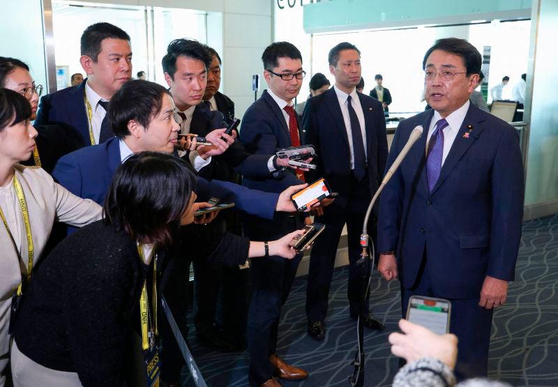 Japan’s Economic Revitalization Minister Ryosei Akazawa (R) answers questions from reporters before departing for his visit to the US at Haneda Airport in Tokyo on April 30, 2025. AFPpix