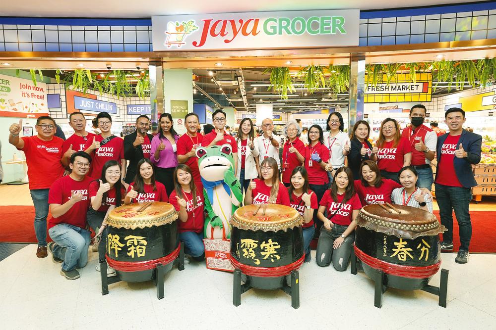 Foo (standing, ninth from right) and deputy CEO Daniel Teng (standing, seventh from left) with their team celebrating the opening of the ‘pop-up’ store at Sunway Pyramid on Sunday.
