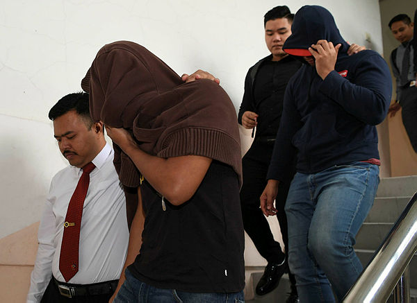 Two policemen, Mohd Ridzuan Sedali, 28, (front) and Muhammad Nurulkiflee Abdul Shukor, 27, pleaded not guilty at the Johor Baru sessions court on Jan 14, 2019. — Bernama