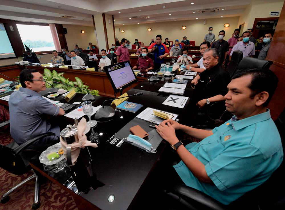 Prime Minister Tan Sri Muhyiddin Yassin attends a meeting with representatives of Muar district traders and industries at the Muar district office today. — Bernama