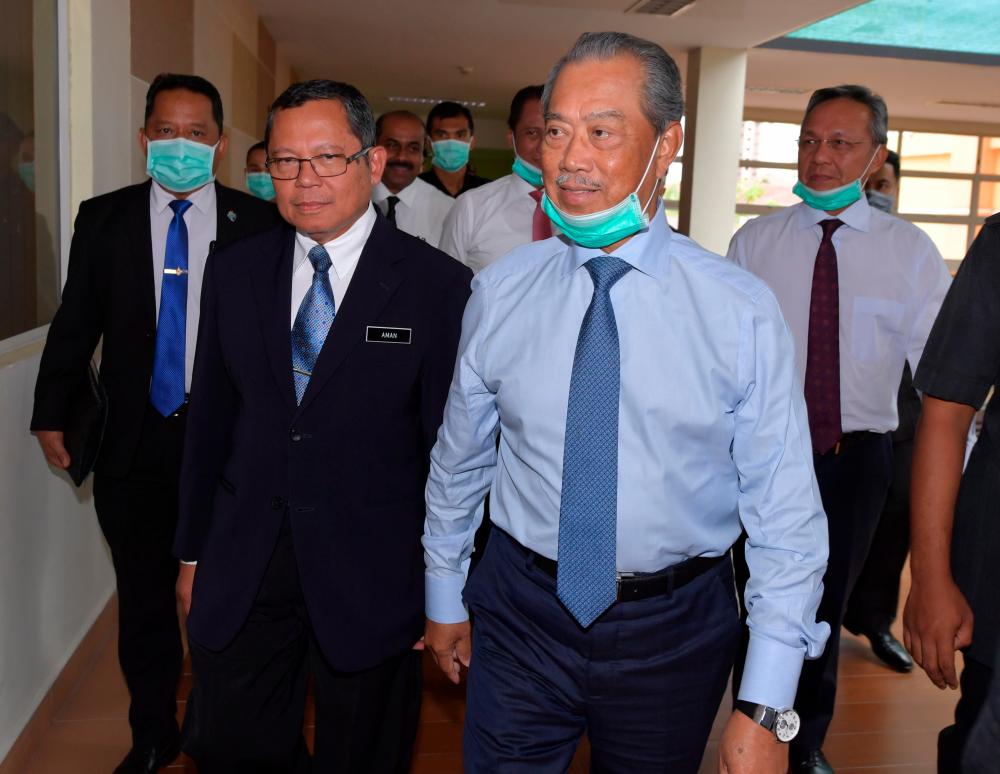 Prime Minister Tan Sri Muhyiddin Yassin accompanied by Mentri Besar Johor Datuk Ir Hasni Mohammad and Johor Health Director Dr Aman Rabu during a working visit to the Permai Hospital in Johor Baru today.- Bernama