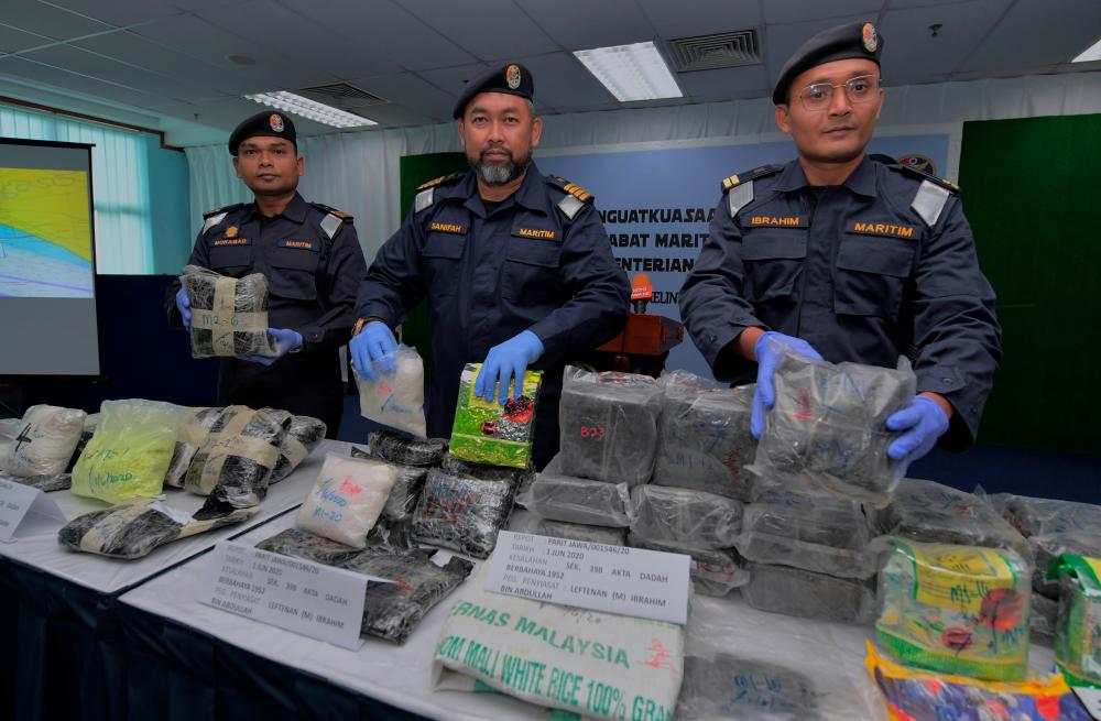 Johor MMEA deputy director (Operations) Maritime Capt. Sanifah Yusof (C) and his staff display seized shabu and ecstacy worth RM2.67 million seized by the MMEA, at a press conference at the Johor maritime headquarters today. - Bernama