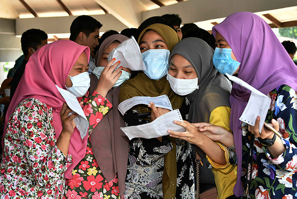 Students who took the SPM 2018 share their excitement when they received their exam results at the Pasir Gudang district education office on March 14, 2019. — Bernama