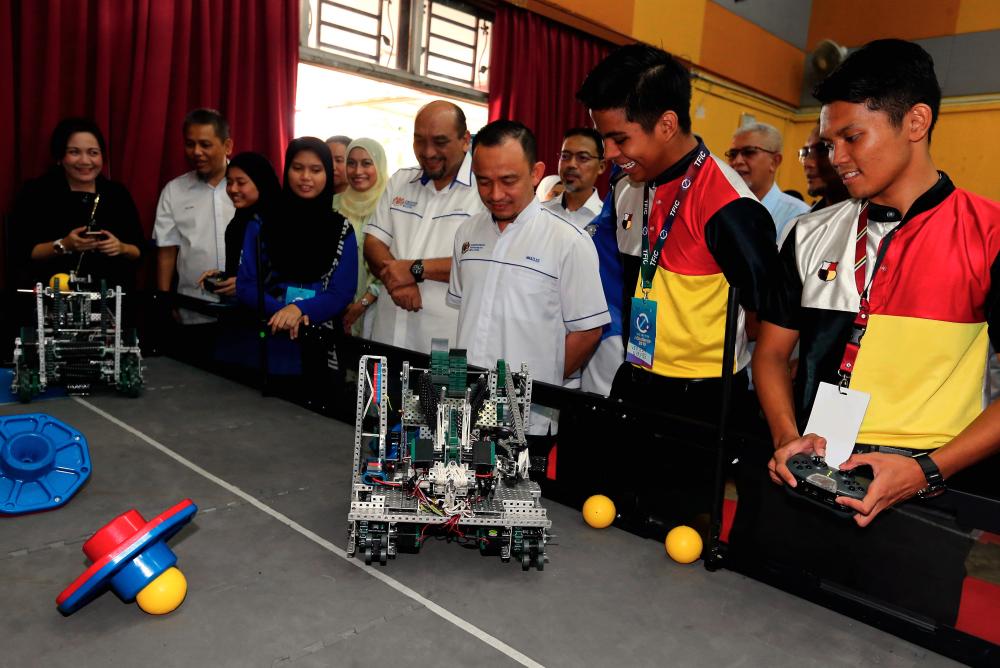Education Minister Dr Maszlee Malik (3rd from R) checks out the robot creations of the Kuala Kangsar Malay College (MCKK) students at the Tun Fatimah i Challenge Competition at Tun Fatimah School, in Johor Baru today. - Bernama