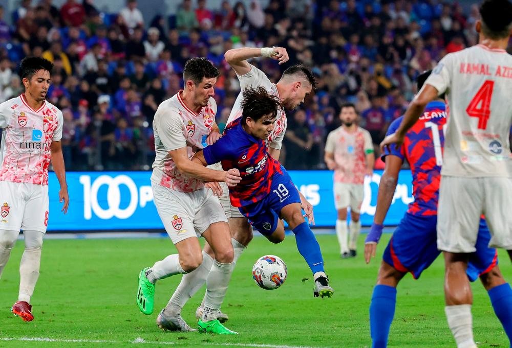 ISKANDAR PUTERI, July 3 -- JDT player Muhammad Akhyar Abdul Rashid (centre) is pushed by Kuala Lumpur City FC player Matko Zirdum (second, left), in the Super League match at Sultan Ibrahim Stadium yesterday. BERNAMAPIX