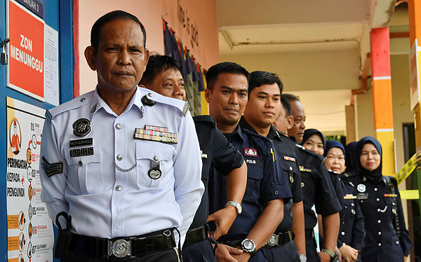 Police personnel wait for their turn to vote at the early voting centre for the Tanjung Piai Parliamentary By-Election, today. — Bernama