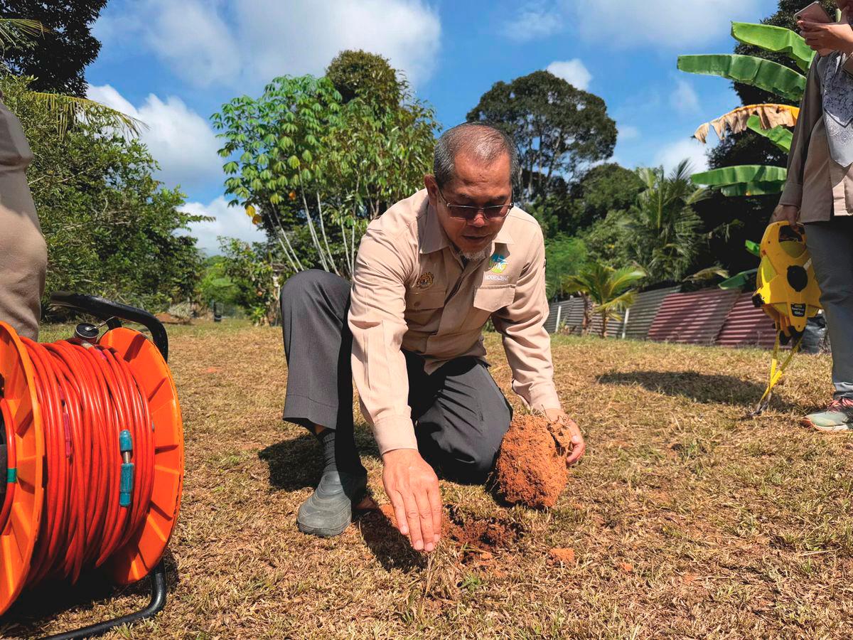 Senior Lecturer at the Faculty of Civil Engineering, Universiti Teknologi Malaysia (UTM), Dr Mohd Nur Asmawisham Alel, uses ABEM Terrameter LS 2 equipment — a resistivity system — to examine the underground structural conditions at the site of ground cracks on a resident’s farm in Jalan Buloh Kasap, Batu 2, here today. – BERNAMA