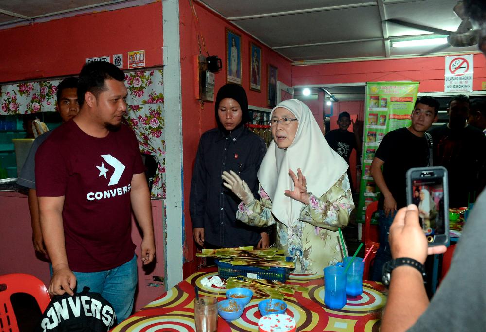 Deputy Prime Minister, Datuk Seri Dr Wan Azizah Wan Aziz, who is also the Pakatan Harapan president, speaks to a patron on a food joint in Pontian, on Nov 3, 2019. — Bernama