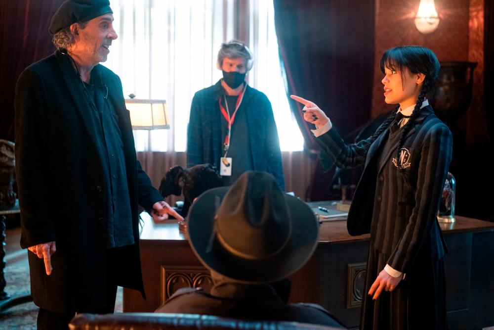 Jenna Ortega (right) and director Tim Burton on the set of ‘Wednesday’. – Netflix