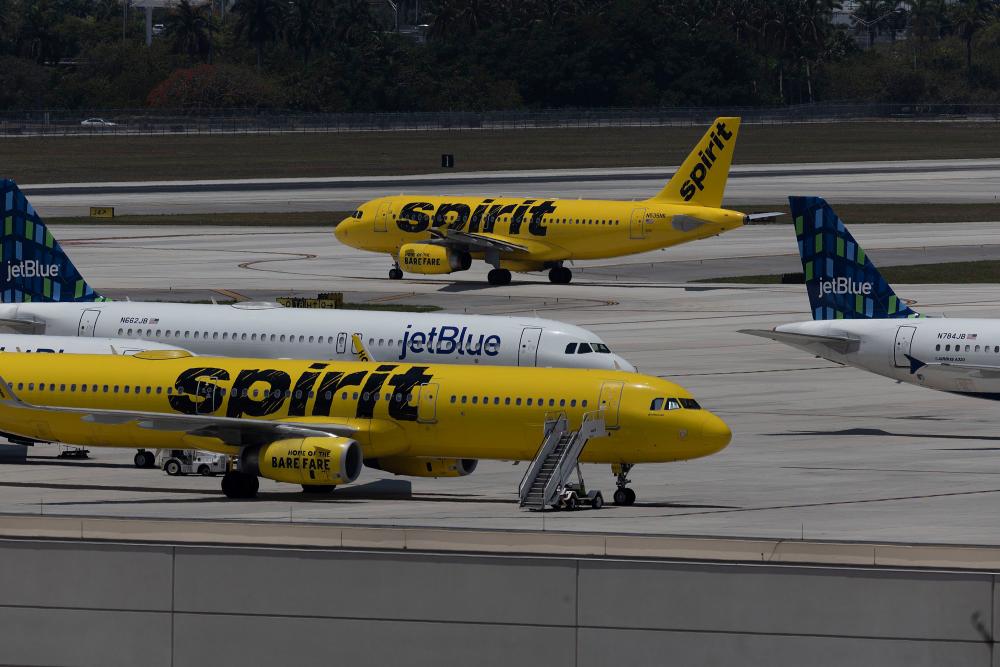 JetBlue Airlines planes are seen near Spirit Airlines aircraft at Fort Lauderdale-Hollywood International Airport, Florida, yesterday. AFPpix