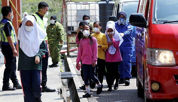 SMK Taman Scientex students suffering from effects of toxic fumes are brought to Dewan Komuniti Taman Pasir Putih for emergency treatment on March 13, 2019. — BBXpress