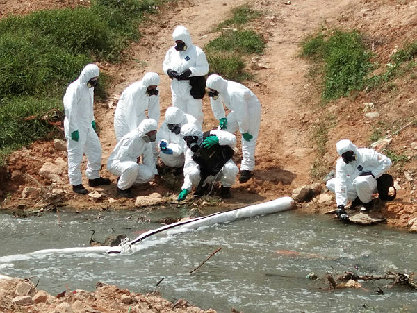 HAZMAT team members conduct an inspection before the cleaning of toxic waste at Sungai Kim Kim, Pasir Gudang on March 14, 2019. — BBXpress