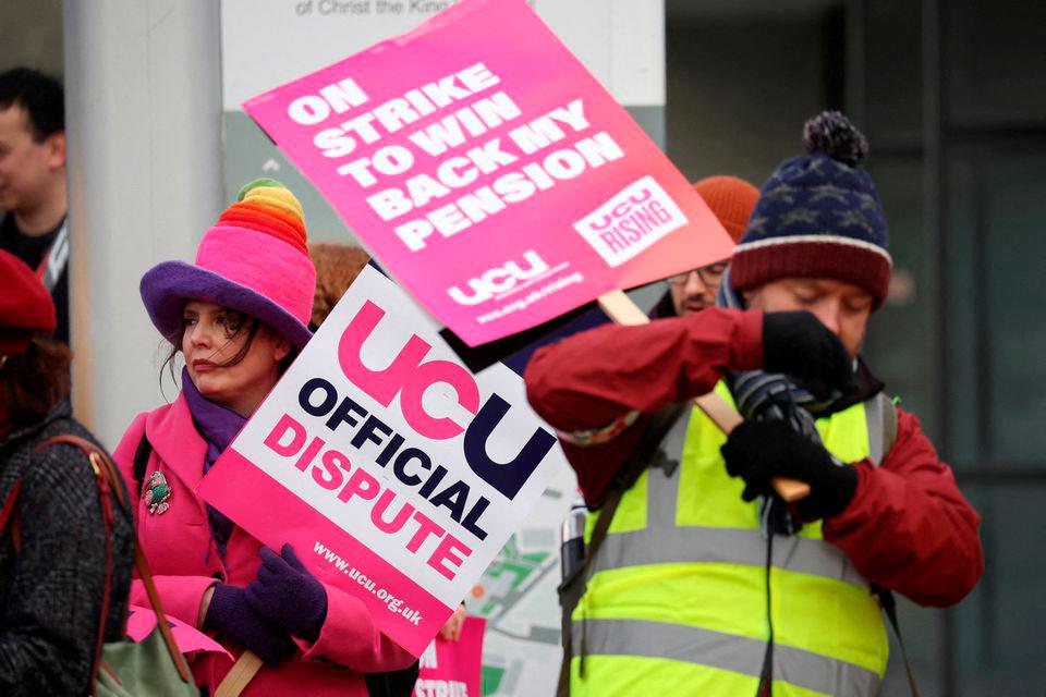 Demonstrators hold signs, as University of Liverpool staff and students attend a rally during a day of strike action, in Liverpool, Britain November 24, 2022. REUTERSPIX